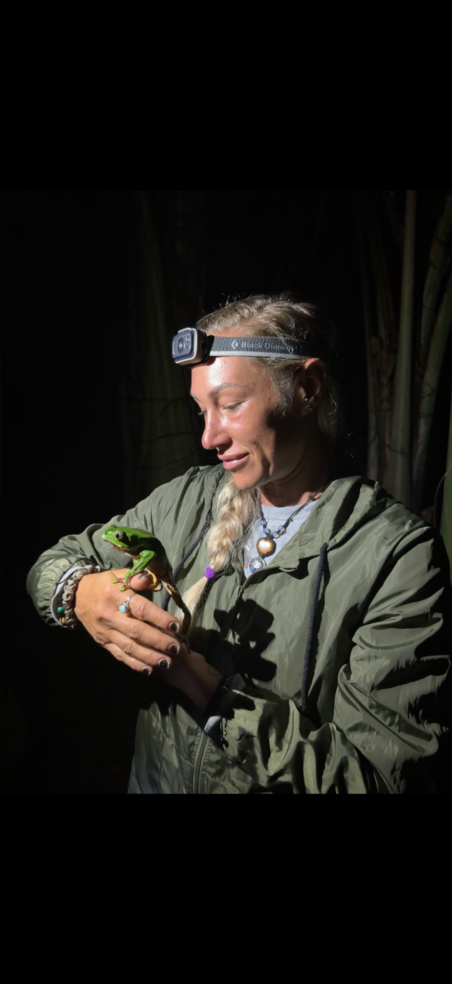 Brittany holding a Giant Monkey Frog during nighttime Kambo ceremony