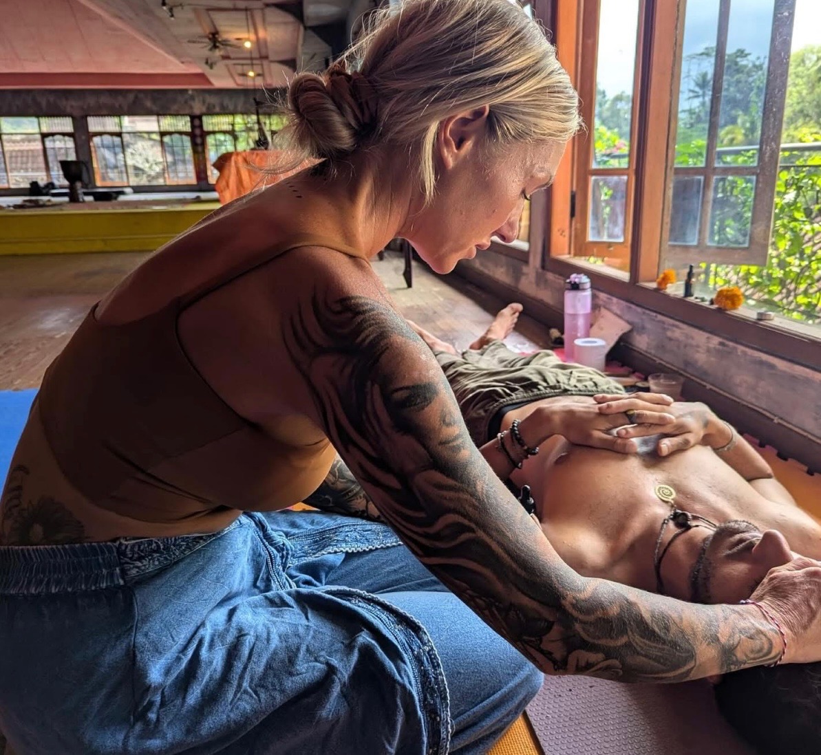 Kambo healing session with practitioner providing hands-on support