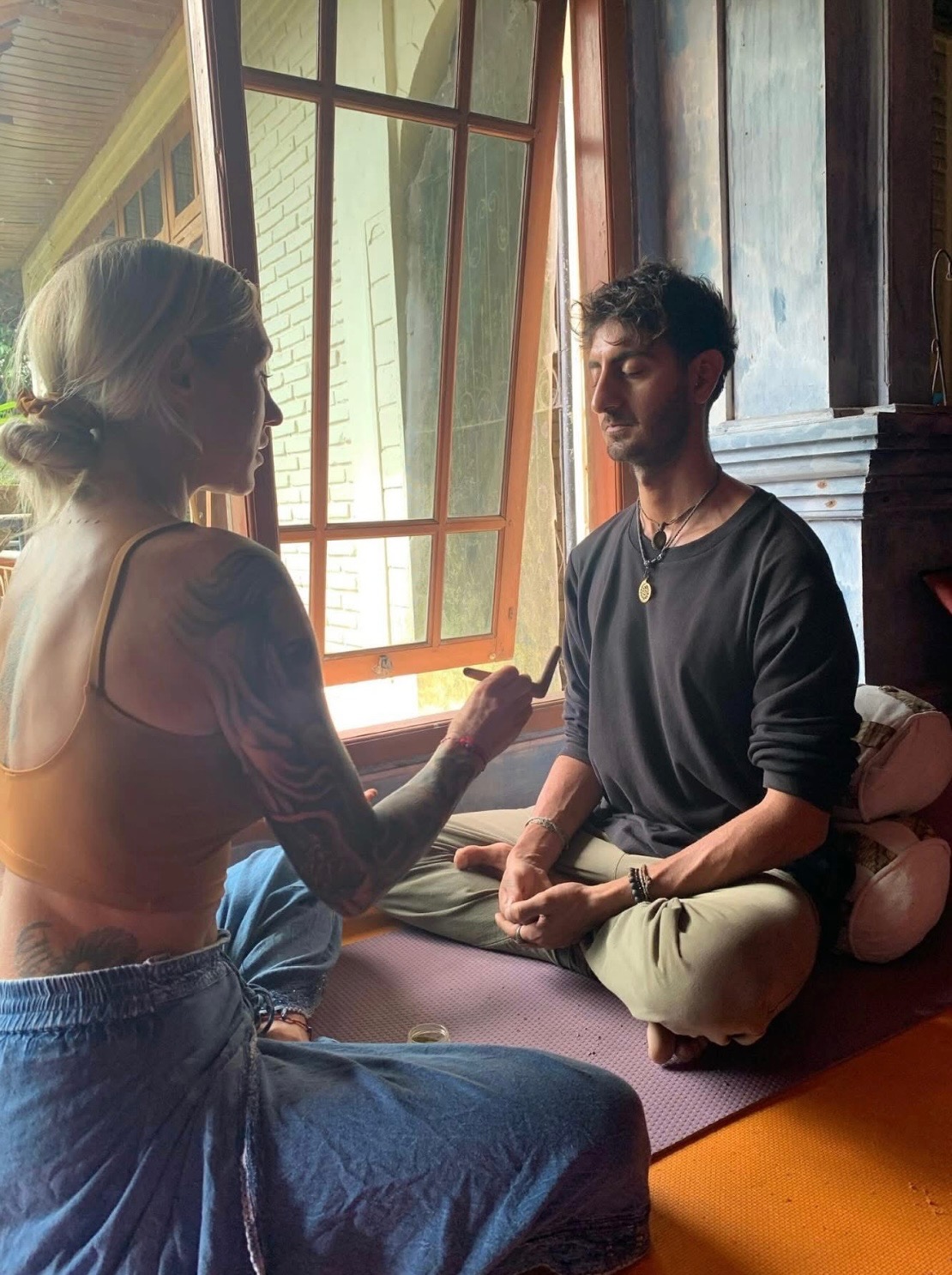 Traditional Kambo ceremony with practitioner and participant in sacred space