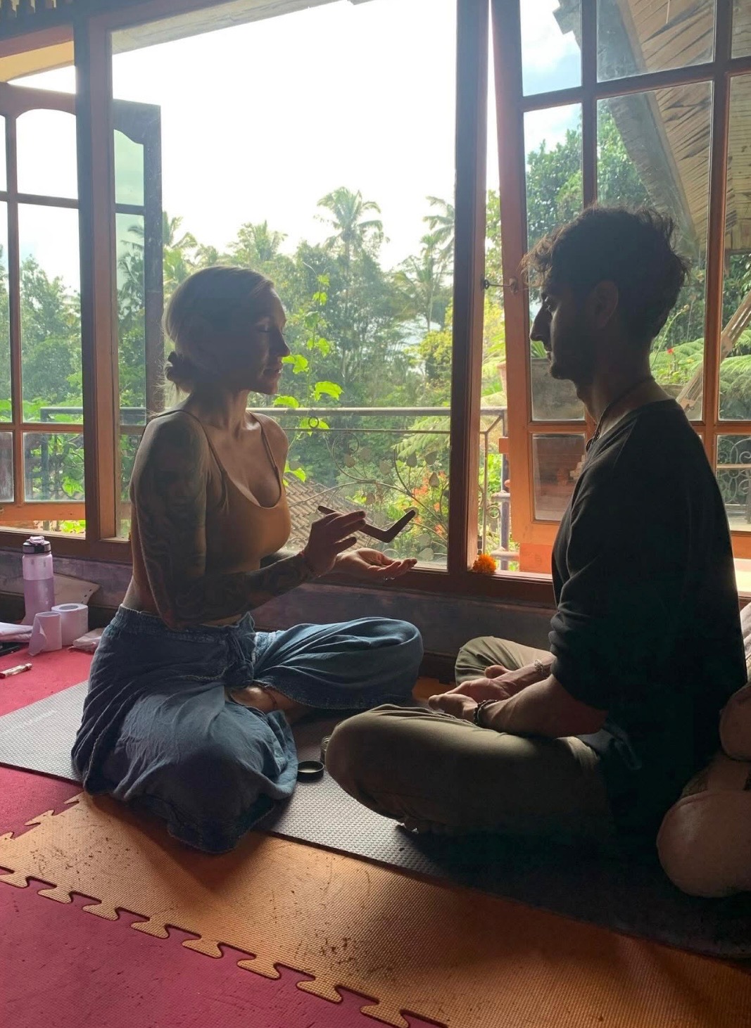 Kambo ceremony participants sharing healing moment in natural light