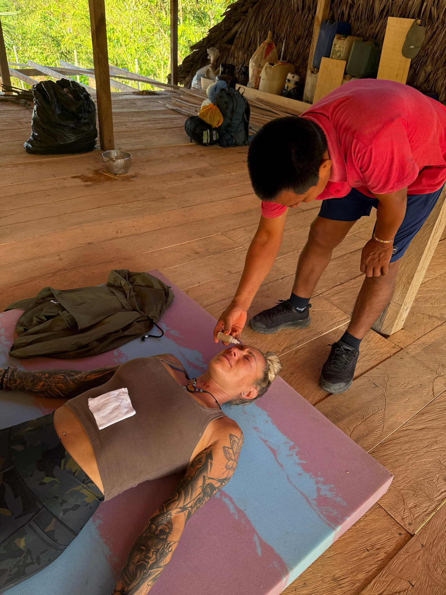 Kambo practitioner applying medicine during ceremony