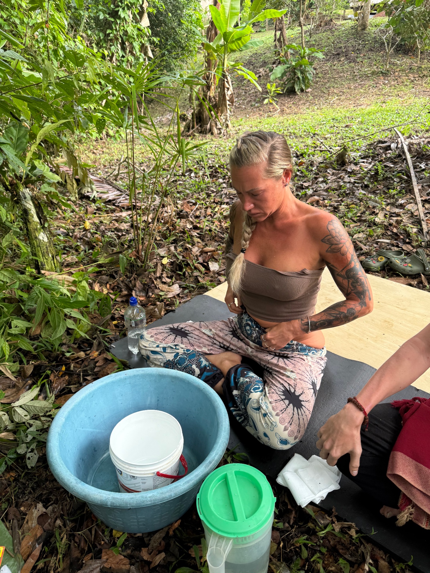 Participant during Kambo ceremony in natural setting